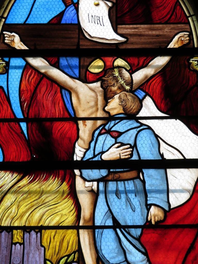 Corporal Guibert Alsini clings to the crucified Christ: a stained-glass window in the church of the commune of Monbert
