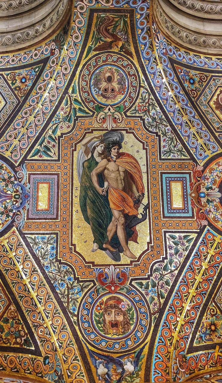 Vault mosaic of Orpheus with a lyre and Eurydice in a green robe on a gold ground, framed by ornament and masks.