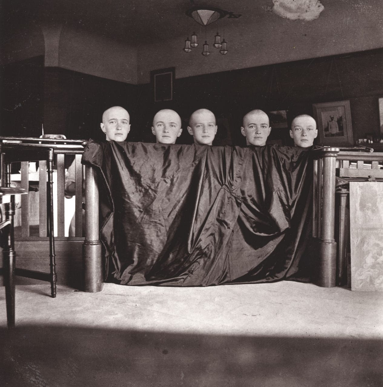 Grand Duchesses Anastasia, Olga, Maria and Tatiana and Grand Duke Alexei Romanov photographed with their heads shaved after measles, June 1917