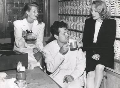 Orson Welles sipping coffee with Rita Hayworth and Marlene Dietrich in 1945
