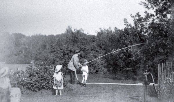 Alexander III with his children watering trees in the garden