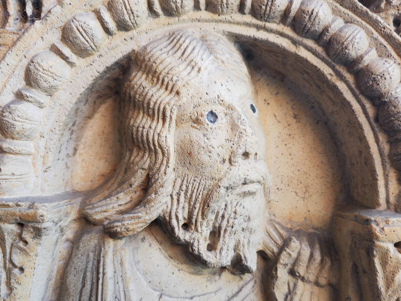 Those eyes opposite, or rather the metal dots where the eyes should be, on the saint's bas-relief in Modena Cathedral