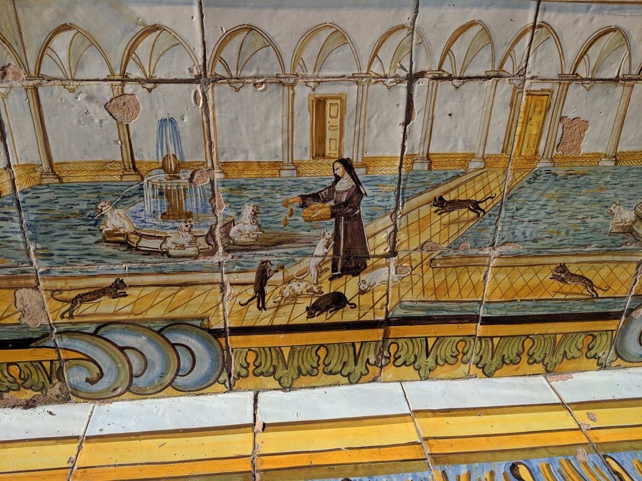 A Nun Feeds the Cats on the Majolica of the Neapolitan Religious Complex of Santa Chiara