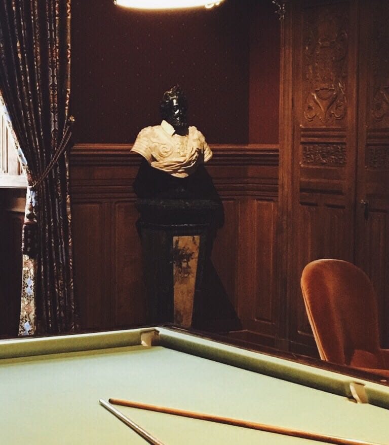 There is a rule: if you cannot play billiards, you must at least be able to hold up your end of a conversation about Henri IV, whose bust stands in the billiard room