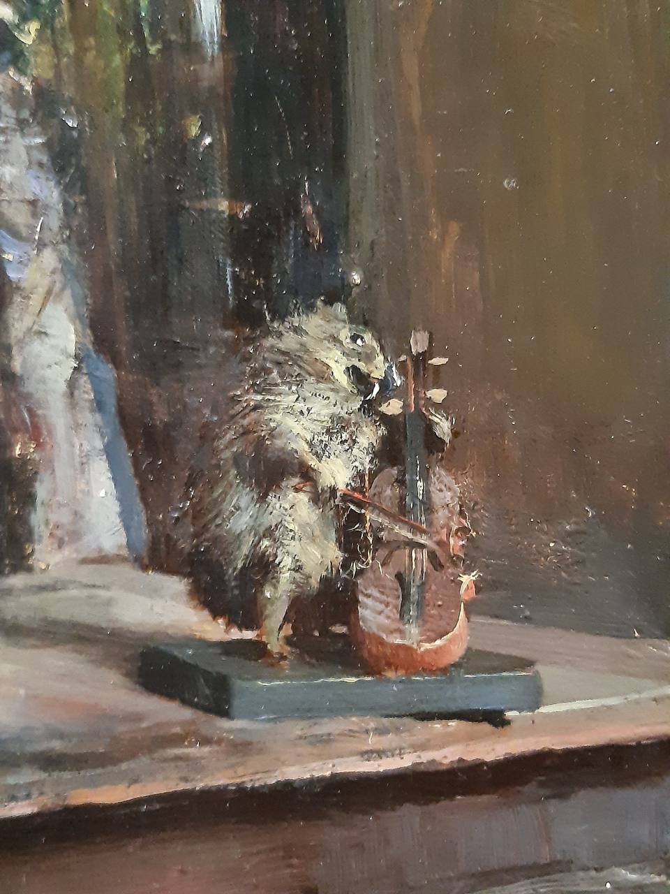 Detail of an oil painting: a hedgehog stands upright beside a small cello on a dark stand against a brown background.