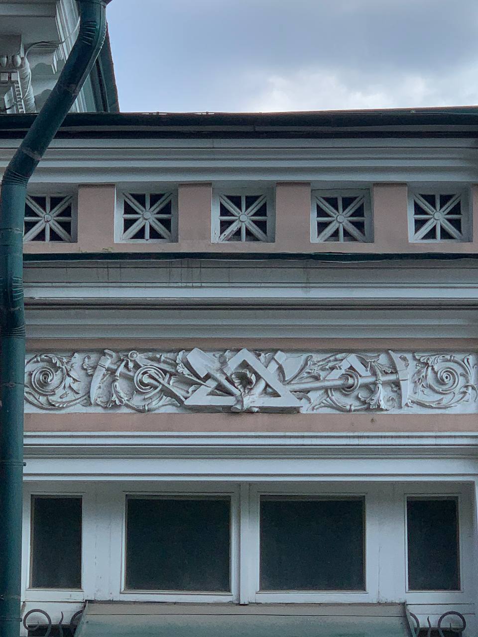 Triangle on the frieze of architect Faleev's house in Gagarinsky Lane as the emblem of civil engineers