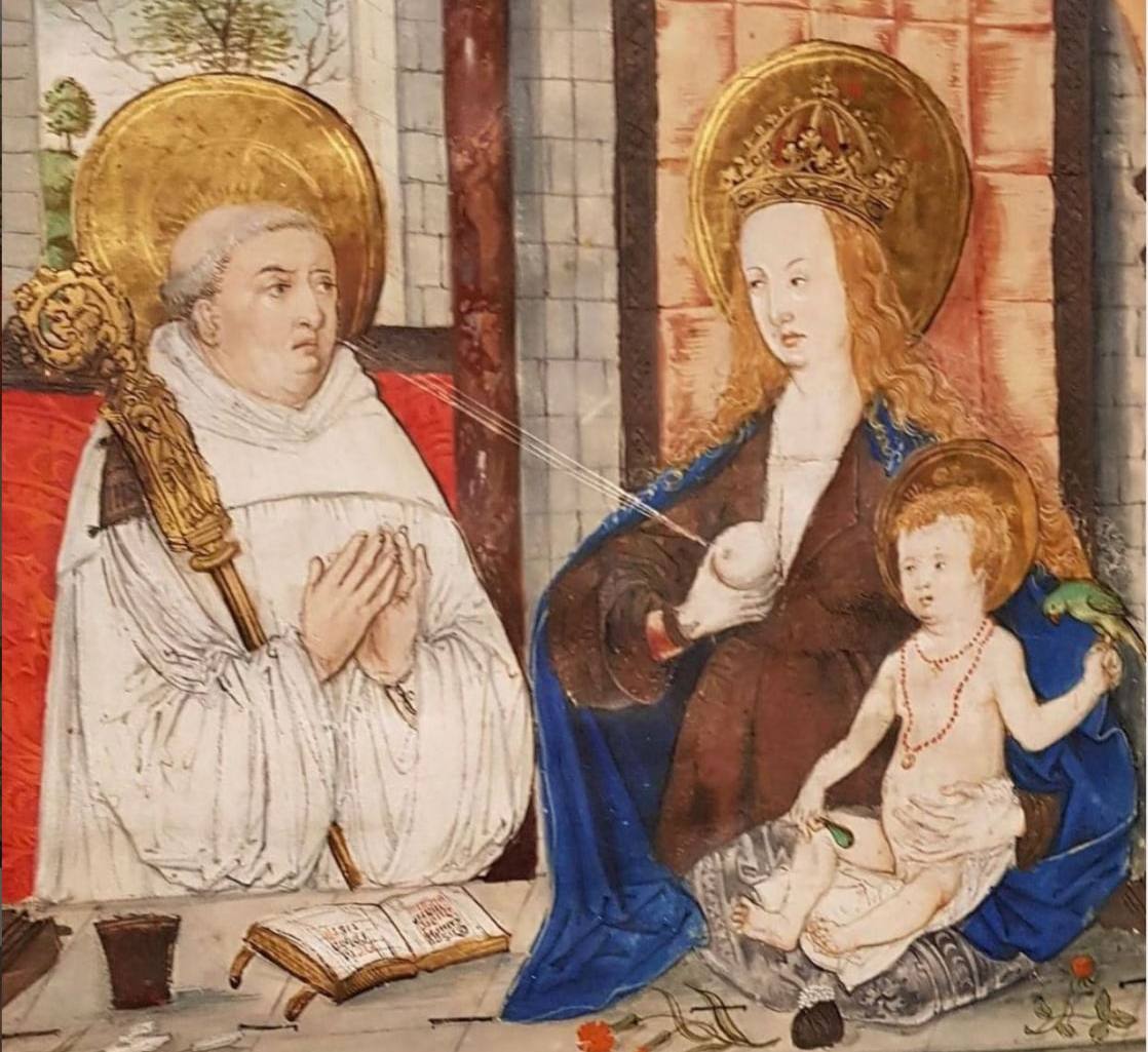 Medieval miniature of a haloed monk with a crozier praying before the Virgin and Child, a stream of milk running from her breast to him.