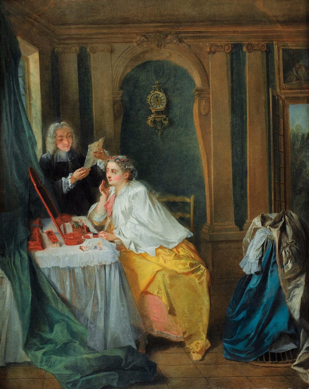 A young woman in a yellow skirt and white wrap sits at a dressing table with a mirror, while a man in dark clothes beside her holds a sheet of paper.