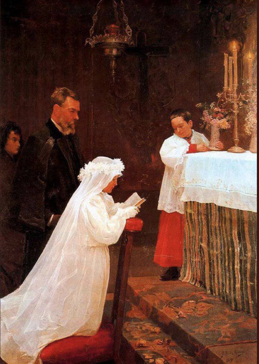 A girl in a white dress and veil kneels at an altar holding a book, beside a man in a dark coat and an altar boy.