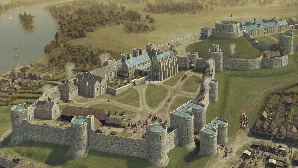 Aerial view of a medieval castle: stone walls with round towers, a Gothic chapel, a keep on a mound, a small town outside the walls and a river at left.