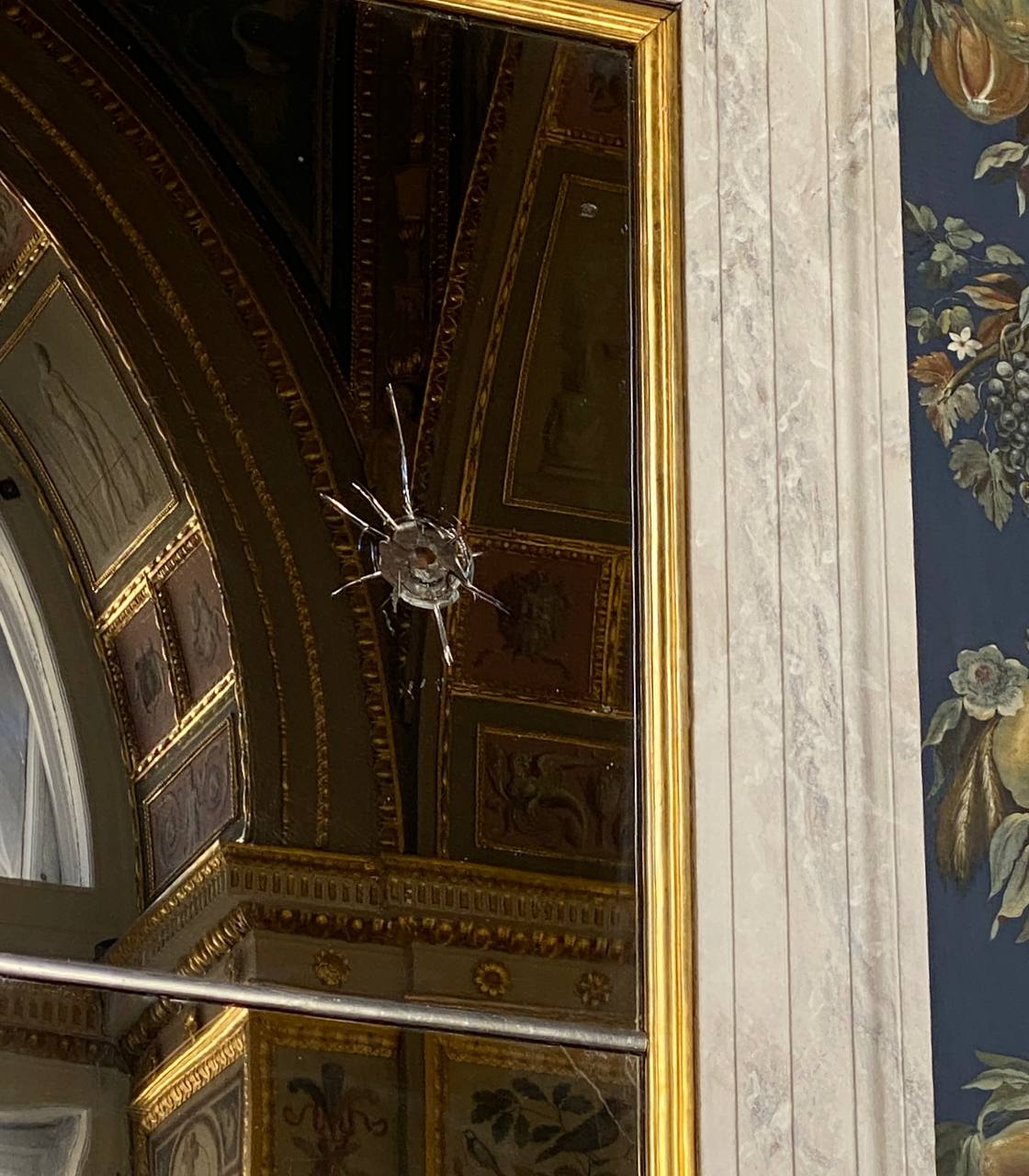 A Bullet Mark in the Mirror