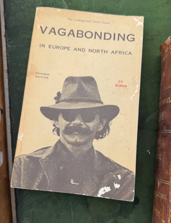 Потёртая обложка книги «Vagabonding in Europe and North Africa» Эда Бурина с фотографией мужчины в шляпе и тёмных очках.